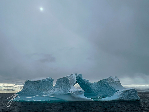 "Ice Arch Under a Cloudy Sun"