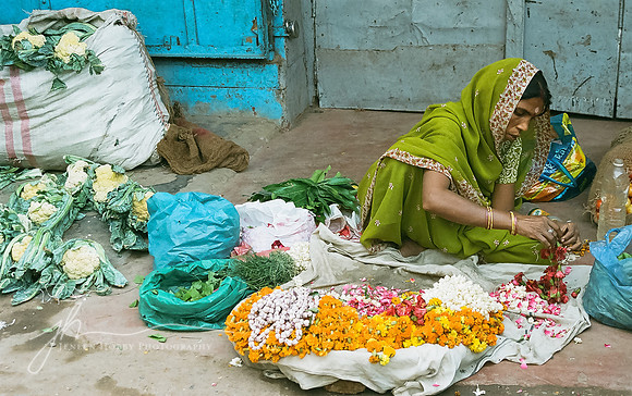 Woman making offerings for the nightly lighting ceremony on the Ganges, Varanasi, India